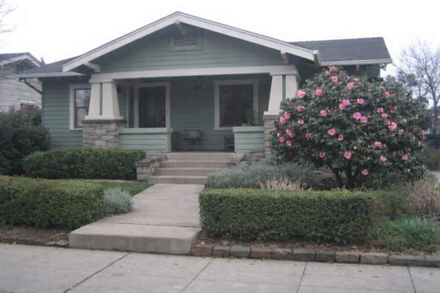 A Land Park bungalow with a low porch and a clipped front garden