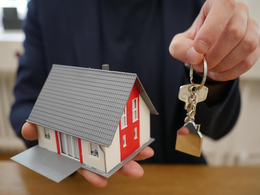 A set of house keys resting on a document at a closing