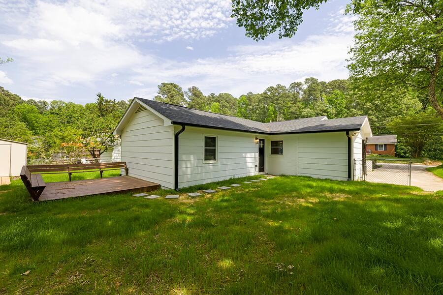 A white bungalow in Fair Oaks behind a planted front garden